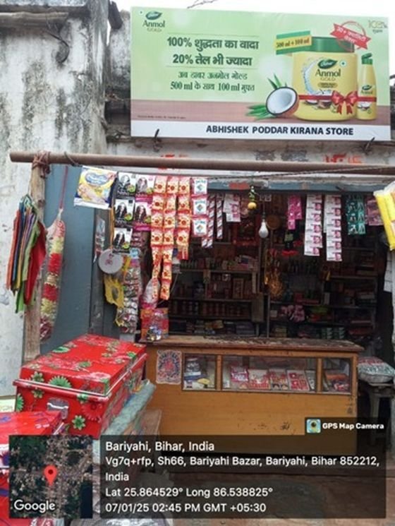 Anmol Coconut Oil dealer board at a kirana store
