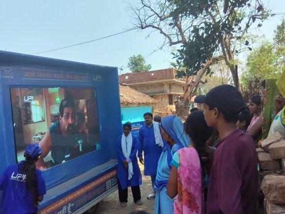 UPI LED van activation with villagers gathered around the screen