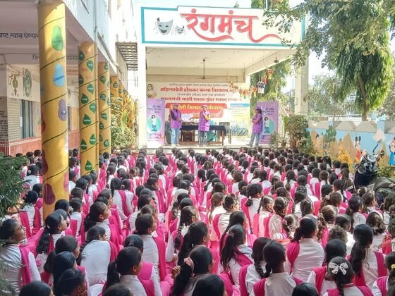 Wide view of students seated at a school event near the Rangmanch stage