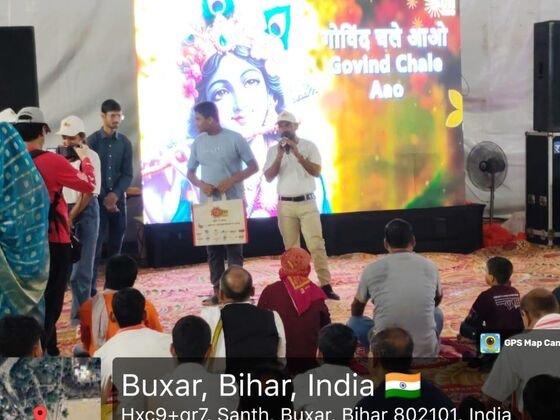 Host on stage with LED screen display during the Sun Neo mela event